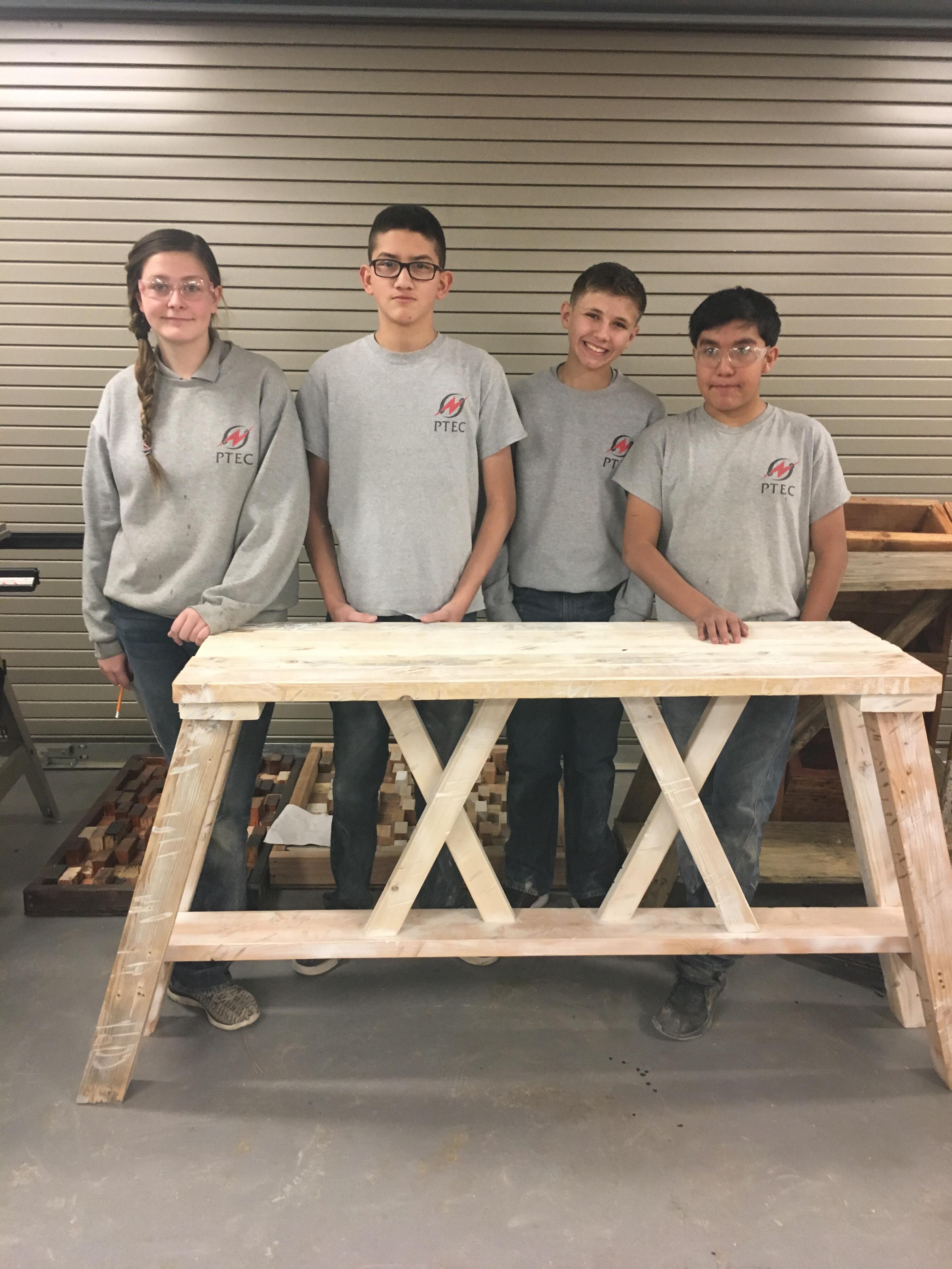 students with table they made
